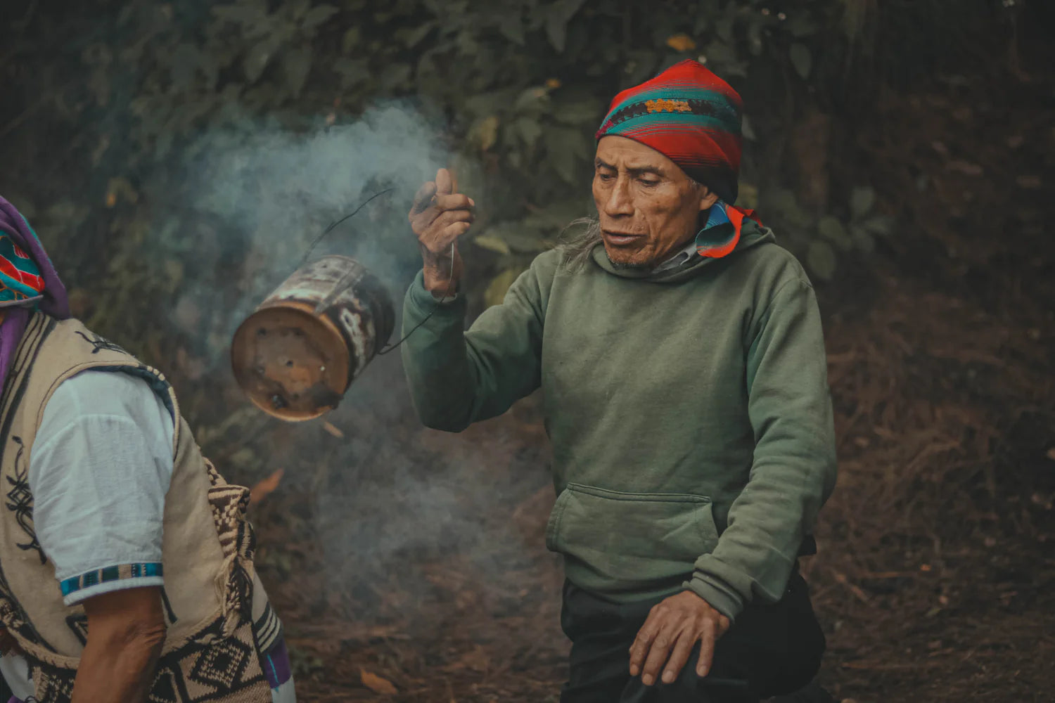 Maya spiritual leader blesses the ceremonial cacao with incense during a cacao ceremony