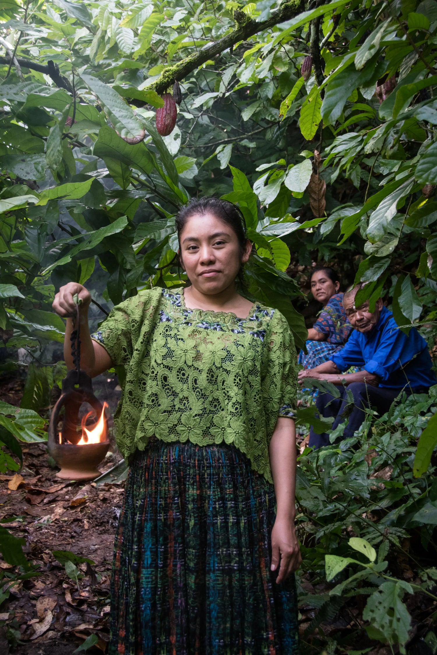 Maya women in the jungle with incense and other indigenous people in the background