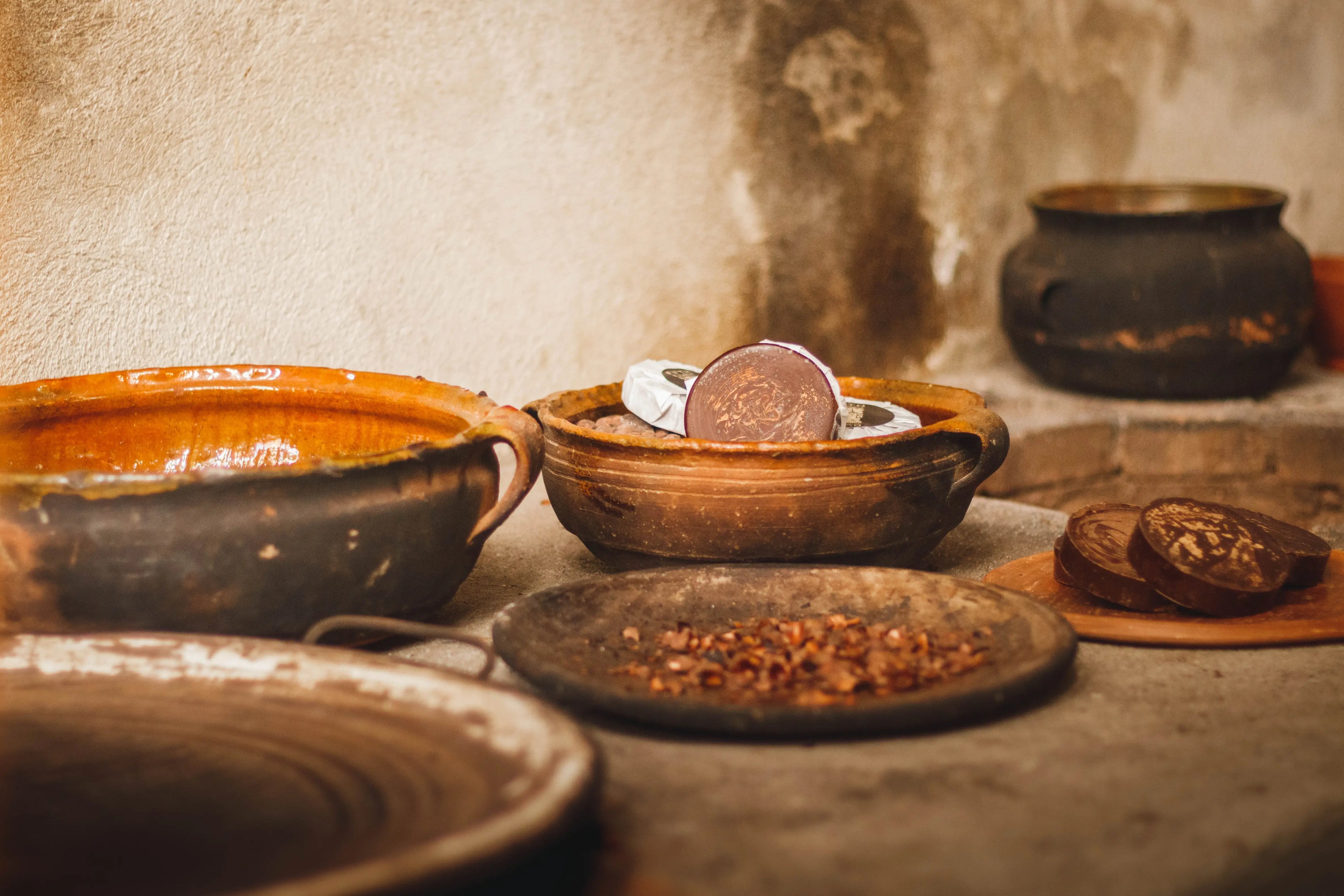 ceremonial cacao in a clay bowl on an old wooden table