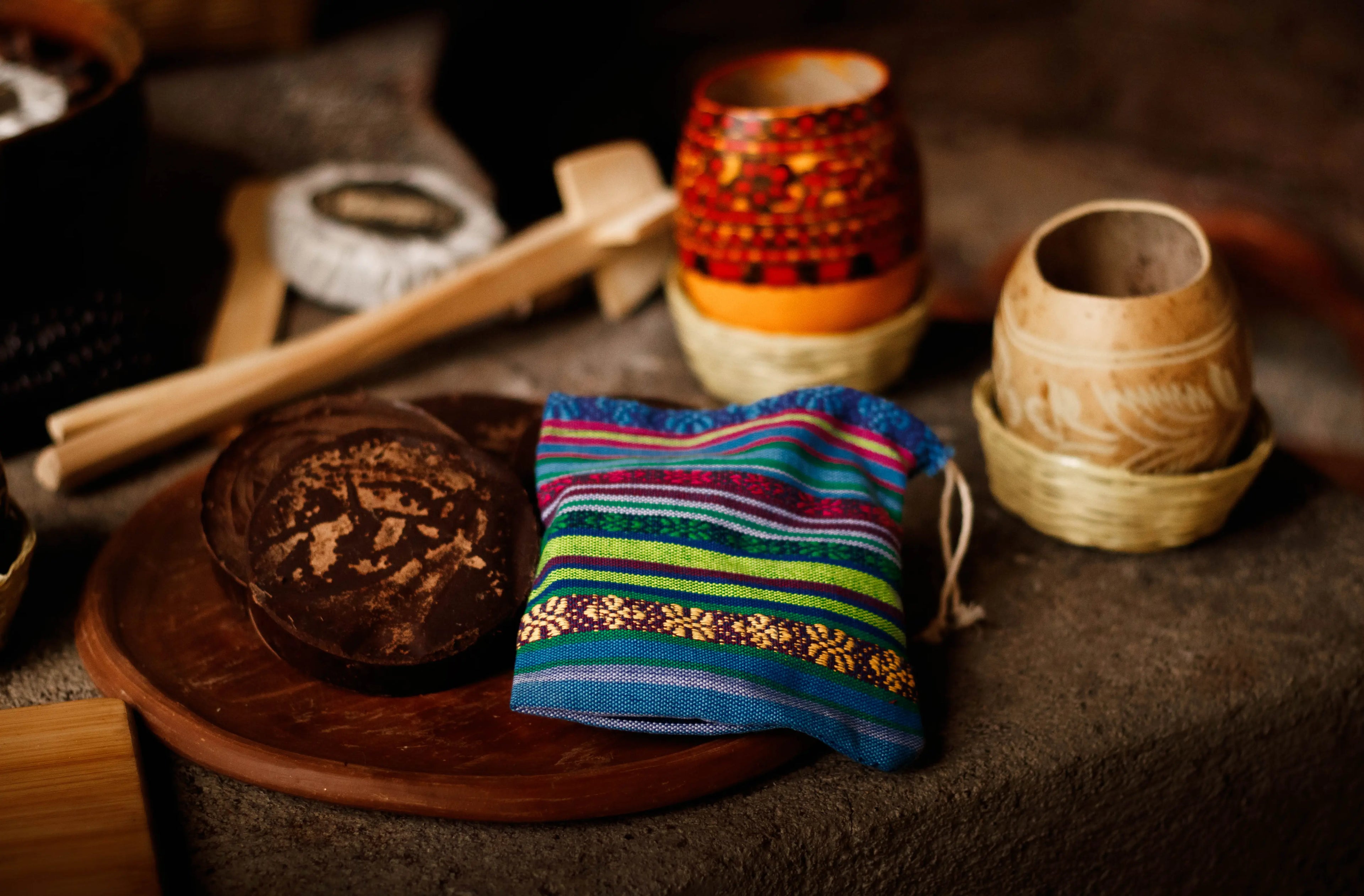 Ceremonial maya products on a table: Ceremonial cacao, Jicaras, Molonillos